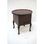 MAHOGANY SEWING TABLE with a circular lift up tray top revealing a satin lined interior above a