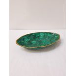 GREEN MALACHITE OVAL DISH with a gold painted rim, 23.5cm wide