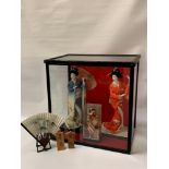 TWO JAPANESE FIGURES OF GEISHA GIRLS IN GLASS CASE both geisha girls in tradition costumes, the case