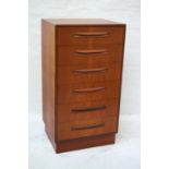 G PLAN TEAK TALL CHEST OF DRAWERS with a moulded top above six drawers, standing on a plinth base,