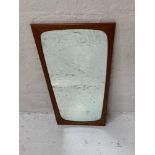 RETRO TEAK FRAMED WALL MIRROR of shaped outline, 70cm x maximum 37.5cm