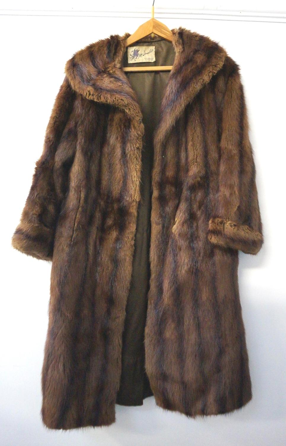 LADYS MUSQUASH COAT with a shawl collar, inside pocket and two outer pockets, bearing a trade