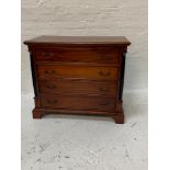 TEAK CHEST with a moulded top above four long drawers flanked by columns, standing on bracket