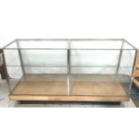 VINTAGE SHOP DISPLAY COUNTER with a glass top and sides and a sloping glass front with internal