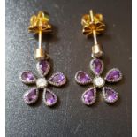 PAIR OF AMETHYST AND DIAMOND CLUSTER EARRINGS the flower head drops on each formed with pear cut