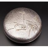 JAPANESE SILVER KOGO INCENSE BURNER of circular form with hammered decoration, the lid decorated