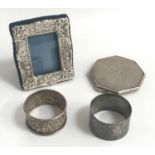 SMALL SELECTION OF SILVER ITEMS comprising a small photograph frame with embossed decoration, London