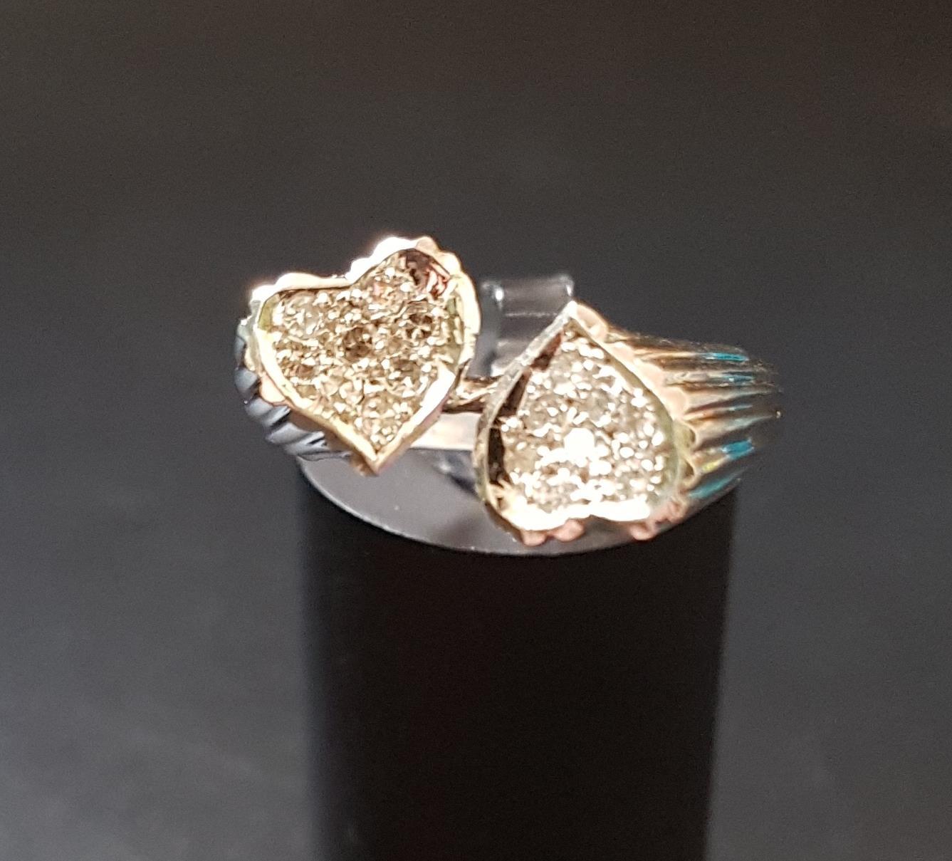 UNUSUAL DIAMOND SET RING in unmarked white gold with pave set diamond heart shaped finials, ring