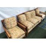 WALNUT BEGERE SUITE with a caned back and arms with loose seat and back cushions above a shaped