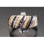 DIAMOND AND SAPPHIRE DRESS RING with alternating diagonal rows of diamonds and sapphires, in