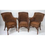 SET OF THREE CANED CONSERVATORY TYPE ARMCHAIRS with shaped backs and arms, standing on bamboo