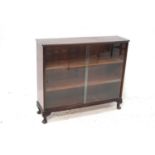 MAHOGANY BOW FRONT BOOKCASE with a pair of glass sliding doors revealing three shelves, standing