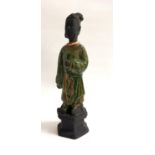 CHINESE SANCI GLAZE FIGURE of a wise man in a flowing green robe, raised on a hexagonal base, 38.5cm