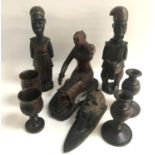 SELECTION OF CARVED WOODEN ITEMS comprising of a pair of candlesticks, two wooden cups, African