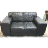 MODERN LEATHER TWO SEAT SOFA in black with broad square arms, standing on chrome supports, 170cm