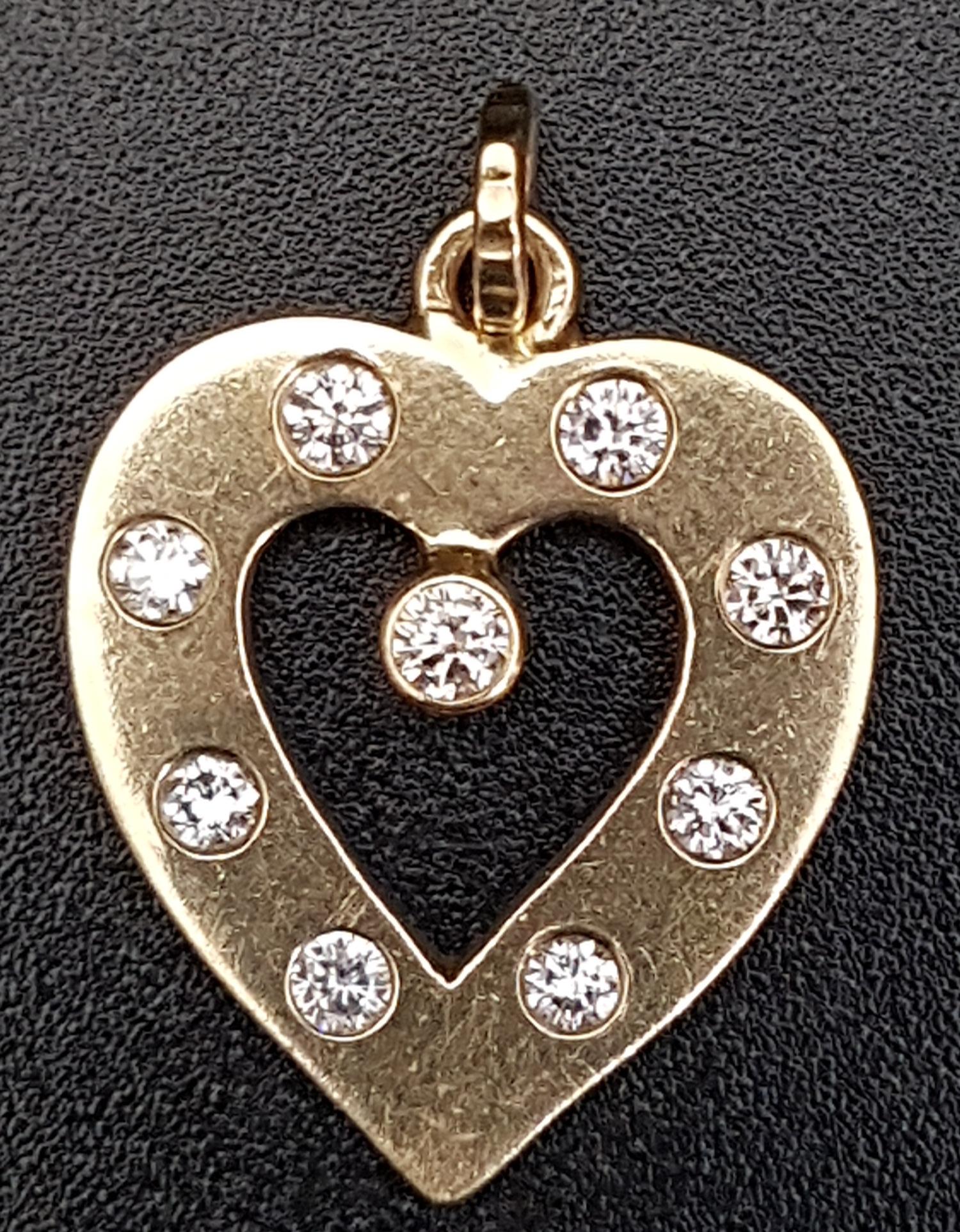 DIAMOND SET HEART SHAPED PENDANT the diamonds totalling approximately 0.35cts, in unmarked gold