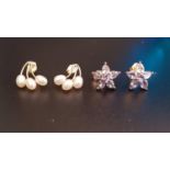 TWO PAIRS OF TEN CARAT GOLD MOUNTED STUD EARRINGS comprising one pair set with three small pearls to