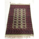 ISHFAN STYLE RUG with a lime green border and central panel with rosette decoration encased by a