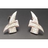 PAIR OF UNUSUAL DIAMOND SET EARRINGS of crossover design with two diamond set tapering sections,