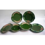 SET OF FOUR EICHWALD POTTERY PLATES of shaped circular form with a green ground, the border