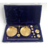 CASED SET OF BRASS MINIATURE APOTHECARY SCALES with weights, in fitted case