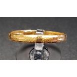 UNMARKED GOLD WEDDING BAND with brushed decoration, ring size X-Y, tests as eighteen carat gold,