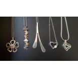 FIVE SILVER PENDANTS ON SILVER CHAINS comprising one with jigsaw style links, two CZ set heart