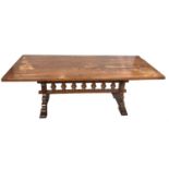 CONTINENTAL OAK REFECTORY STYLE TABLE with a one piece rectangular top standing on shaped end