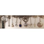 SELECTION OF NINE SILVER PENDANTS ON SILVER CHAINS including an Art Deco marcasite and black stone