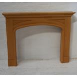 BEECH FIRE SURROUND with a moulded top above an arched opening, 115cm x 147cm
