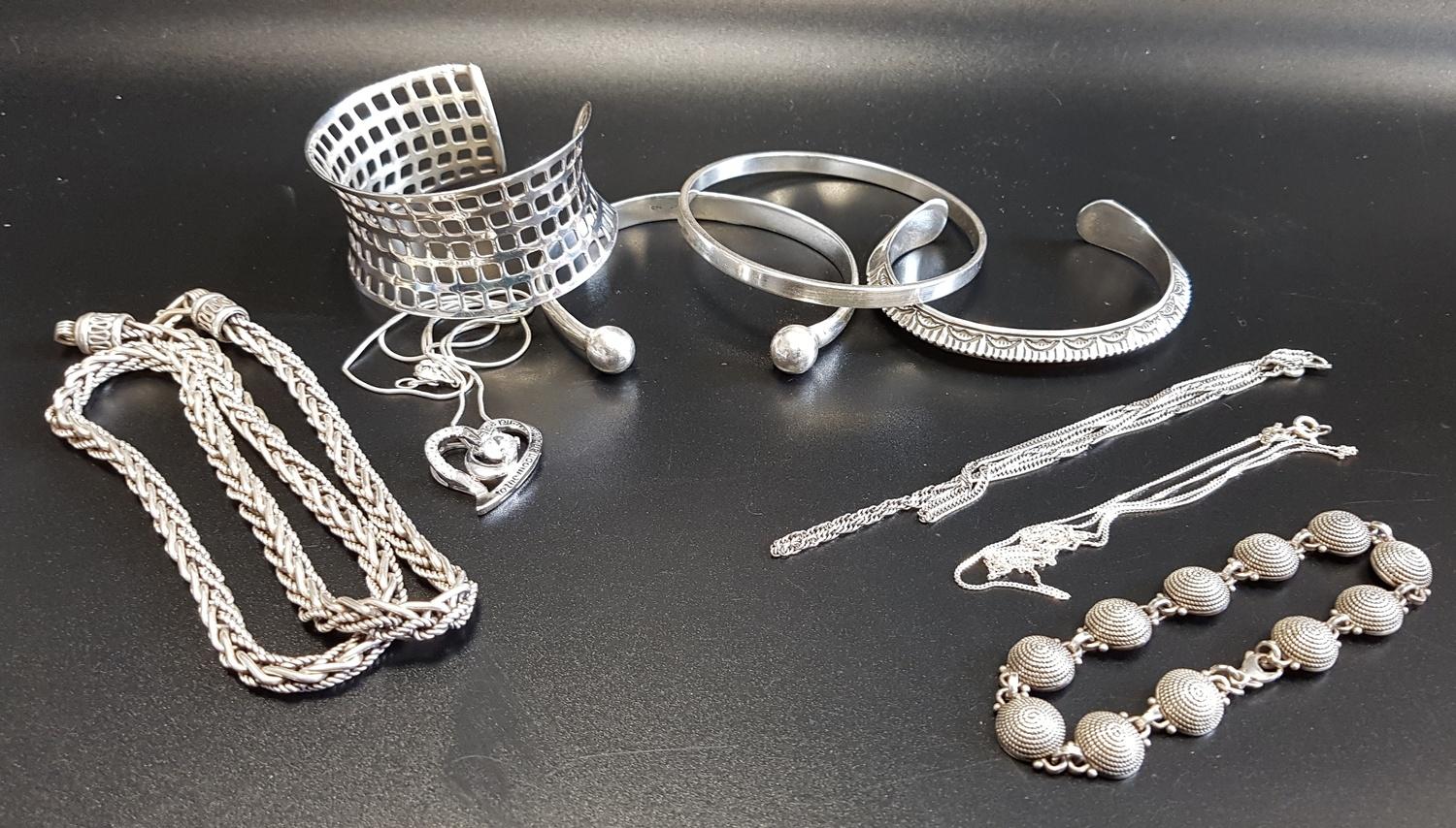 SELECTION OF SILVER JEWELLERY comprising four bangles including one pierced mesh style example; a