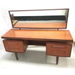 G PLAN TEAK KNEEHOLE DRESSING TABLE with an oblong mirror back above a central flush fitting