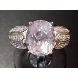 KUNZITE AND DIAMOND DRESS RING the central oval cut kunzite flanked by multi diamond set