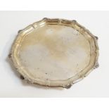 GEORGE V SILVER CARD TRAY the shaped rim with scallop shell detail, raise on three lion paw feet,