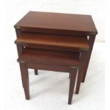 NEST OF MAHOGANY TABLES with brass banded corners standing on tapering supports, the largest 59cm