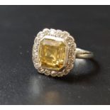 IMPRESSIVE FANCY AND WHITE DIAMOND CLUSTER RING the central square emerald cut fancy diamond