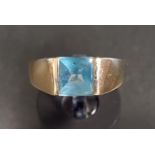 BLUE TOPAZ SINGLE STONE DRESS RING the square topaz with polished dome top, on ten carat gold shank,