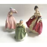 THREE ROYAL DOULTON FIGURINES comprising Southern Belle, HN2229; Sweet April, HN2215; and Fair