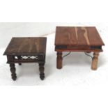TWO TEAK OCCASIONAL TABLES with decorative ironwaork and raised on turned supports, 60cm x 60cm
