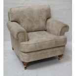 LARGE ARMCHAIR with a shaped back and seat cushion, scroll arms, standing on stout turned front