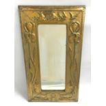 ARTS AND CRAFTS BRASS WALL MIRROR with an oblong embossed frame decorated with birds and flowers and