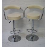 PAIR OF KITCHEN BAR STOOLS with shaped padded backs and chrome arms above circular padded seats,