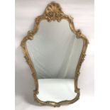 ORNATE GILT METAL WALL MIRROR with a shaped frame surmounted with a shell, 114cm high