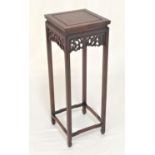 CHINESE ROSEWOOD STAND with a square top above a carved and pierced dragon frieze, standing on plain