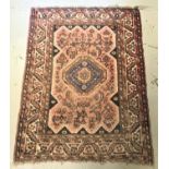 TABRIZ STYLE RUG with a coral central lozenge encased by a multi layered border, 170cm x 130cm
