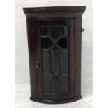 QUEEN ANNE STYLE MAHOGANY BOW FRONT CORNER CABINET with a moulded dentil cornice above an astragal