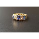 SAPPHIRE AND DIAMOND RING the three graduated oval cut sapphires separated by smaller diamonds, on