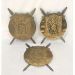 THREE BRASS HERALDIC STYLE SHIELDS centered with an embossed lion rampant surrounded by embossed oak