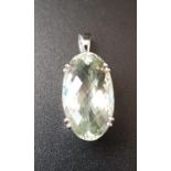 OVAL BRIOLETTE CUT ZOISITE SINGLE STONE PENDANT in eighteen carat white gold mount, the zoisite
