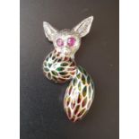 RUBY AND ENAMEL SILVER BUSH BABY BROOCH with ruby eyes, the body and tail divided into colourful